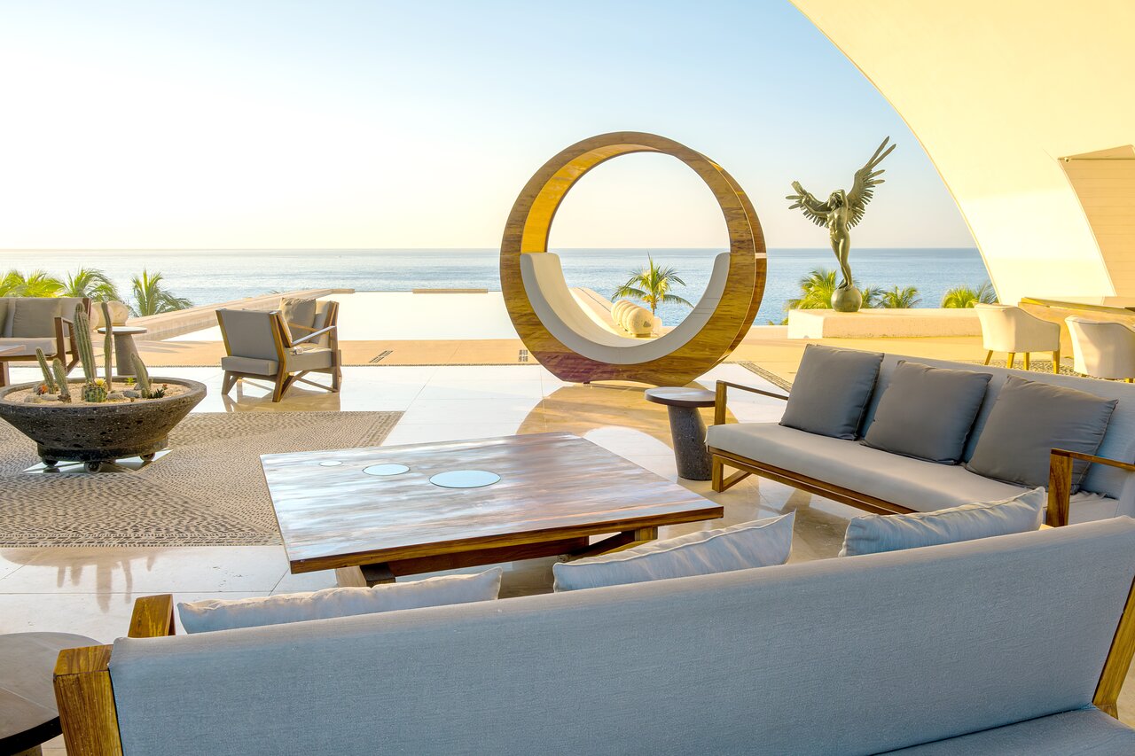 The striking lobby at our oceanfront all-inclusive, adults-only resort in Los Cabos welcomes guests with avant-garde furnishings, curated art, and breathtaking views of the Sea of Cortez. This sophisticated space blends contemporary design with the spirit of Cabo, creating a memorable first impression and the perfect introduction to a refined luxury escape.