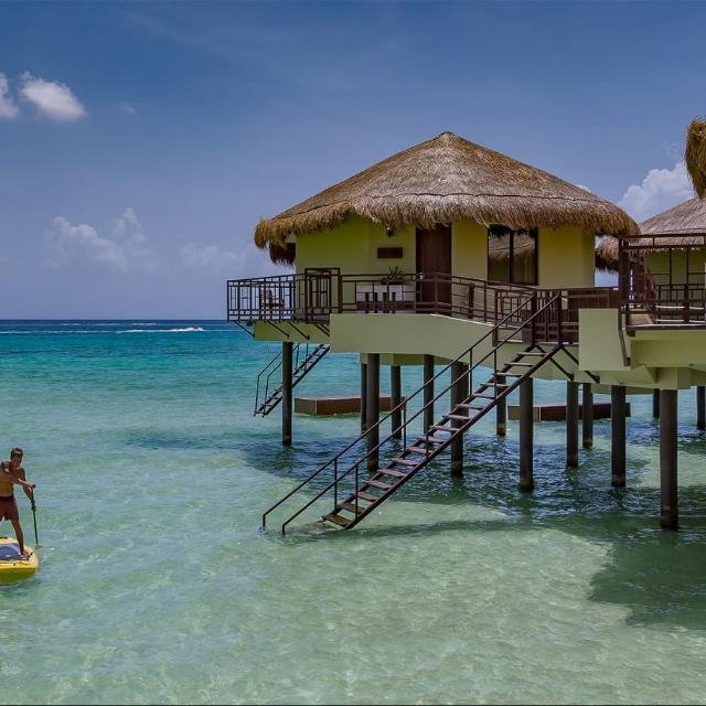 This is an outside view of a Palafito which is positioned directly in the ocean